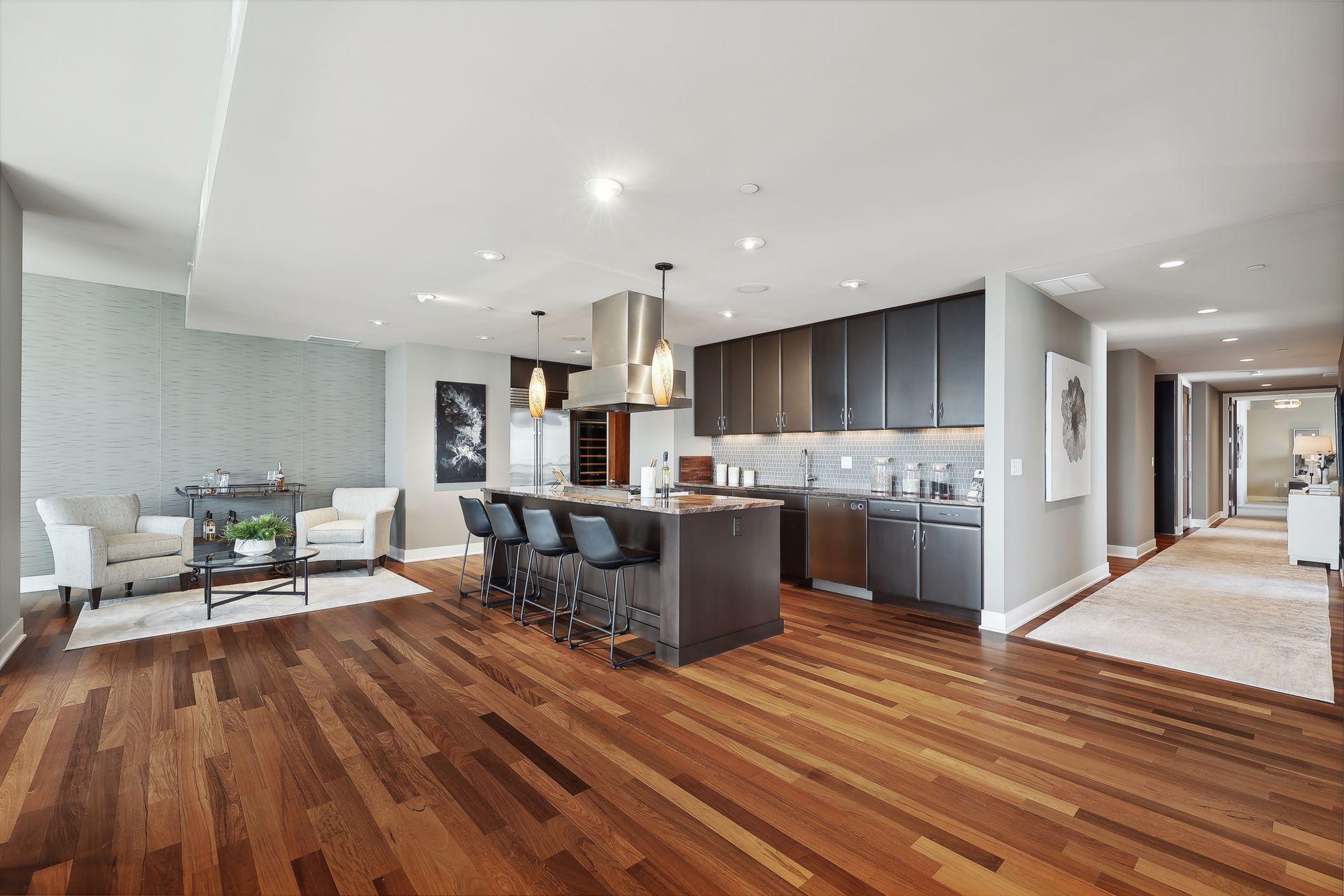 A closer view of the kitchen with seating for exhibit cooking! A fun spot to the left of the kitchen brings guests into the action and conversations. Note the Vent-a-Hood over the island, also in the prep area is a Kitchen-aid trash compactor.