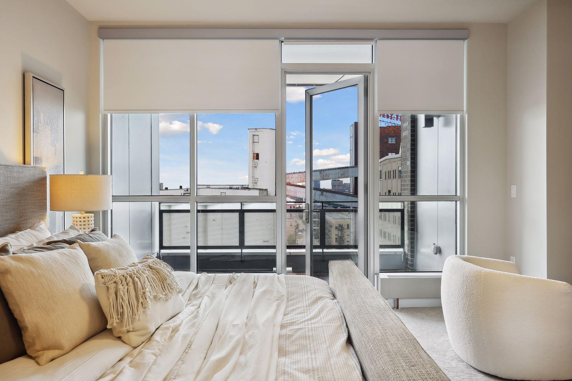 A view taking in the private deck with shades drawn a bit. Everywhere within this condo the views are breathtaking...even from your sleeping area!
