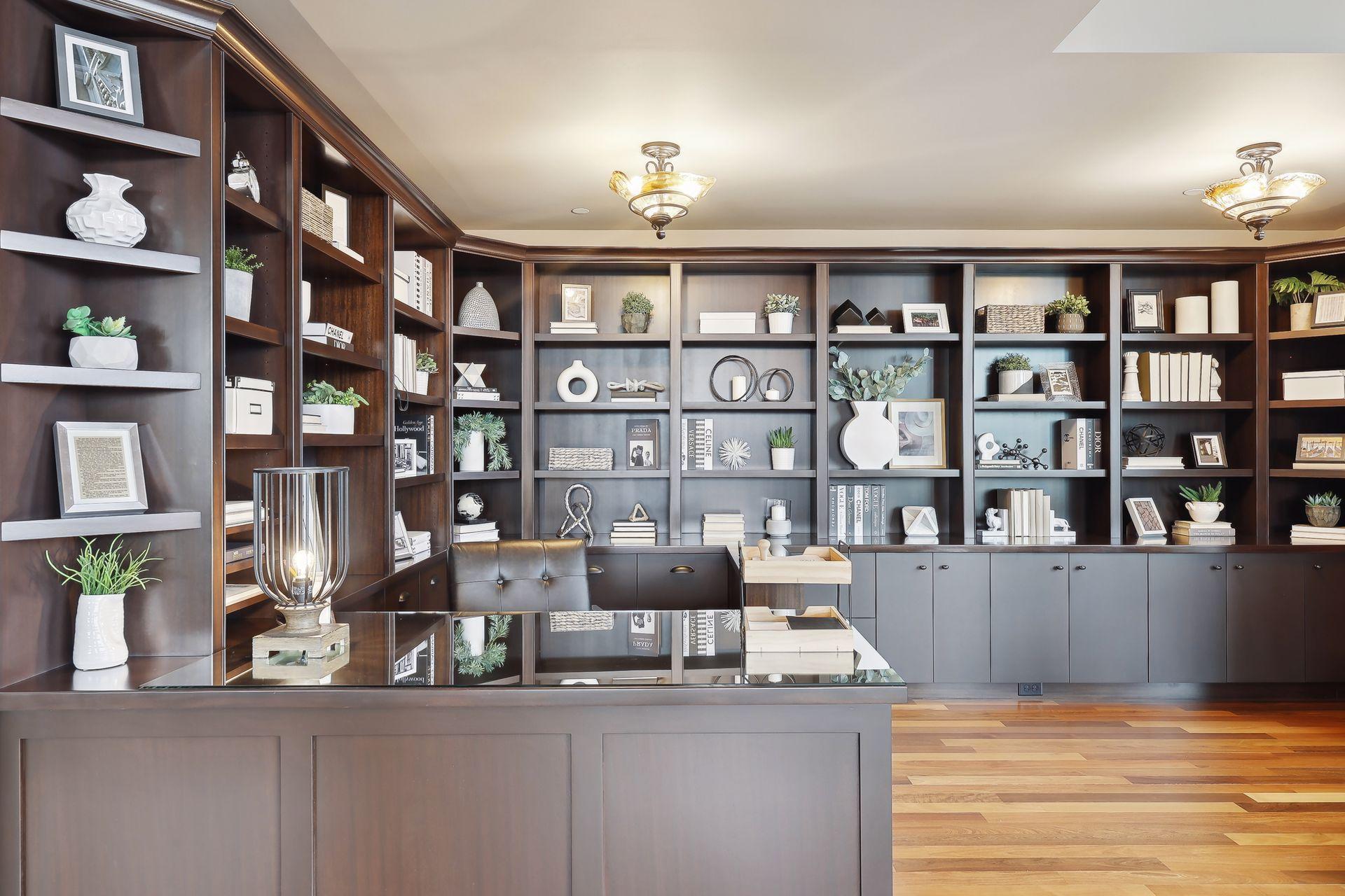 This library/office has a built in desk that looks through the media room.