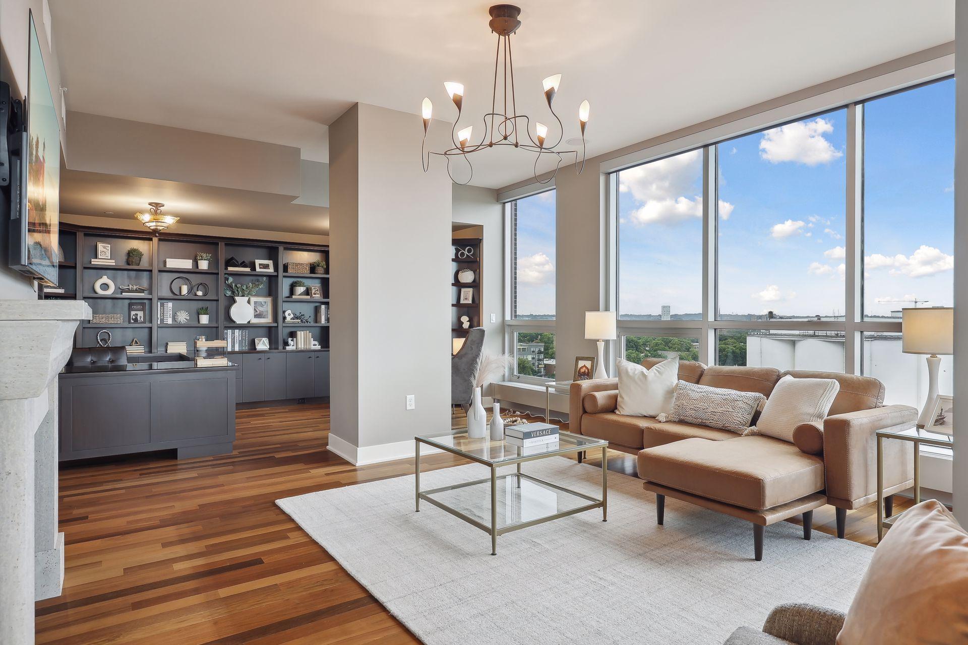 A more expansive view of the media room facing the fireplace and the library/office beyond.