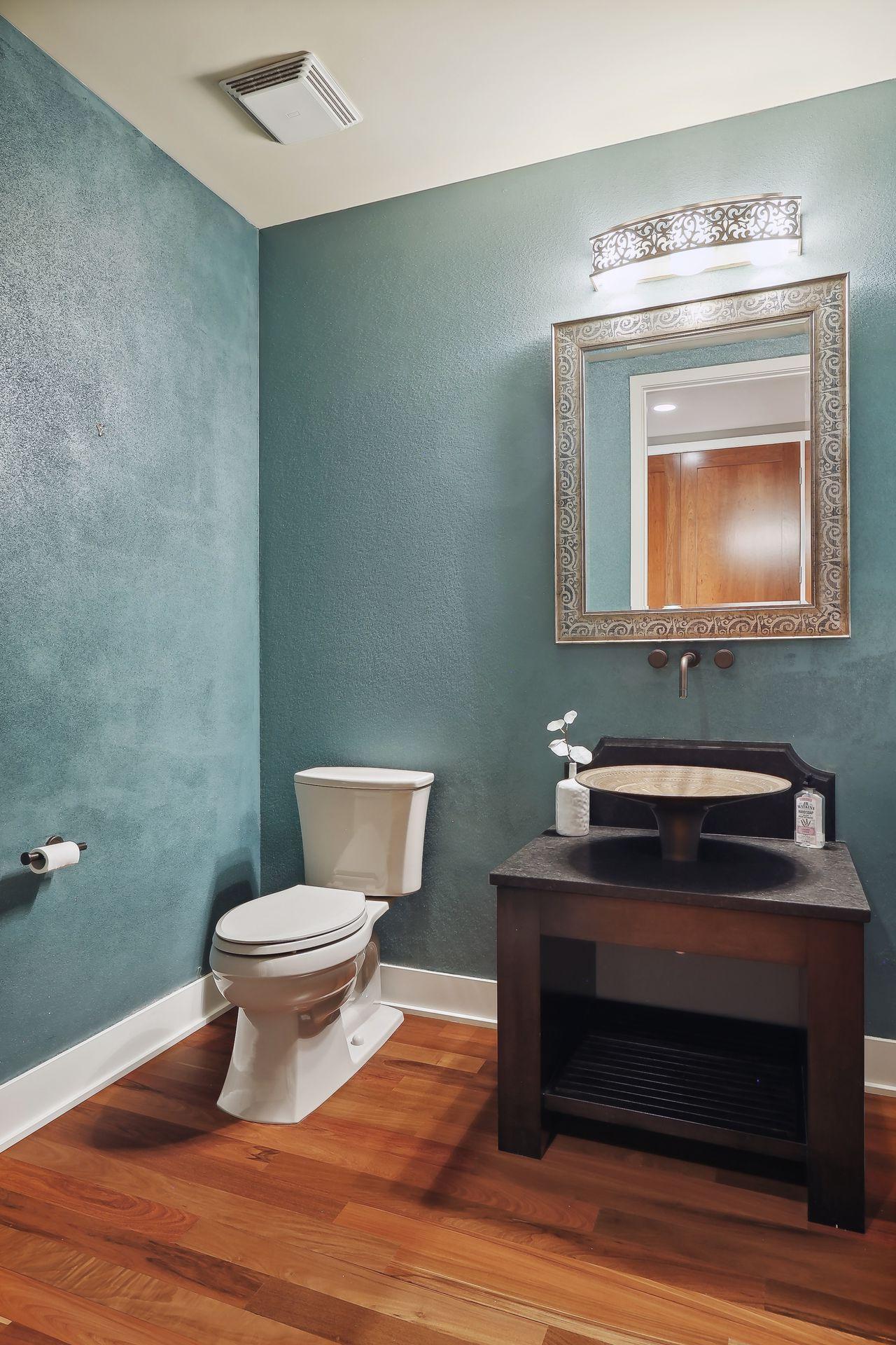 Guest Powder Room: Another dramatic touch commissioned by Carter Averbeck, glass bead walls and a unique brass basin that appears to be floating.