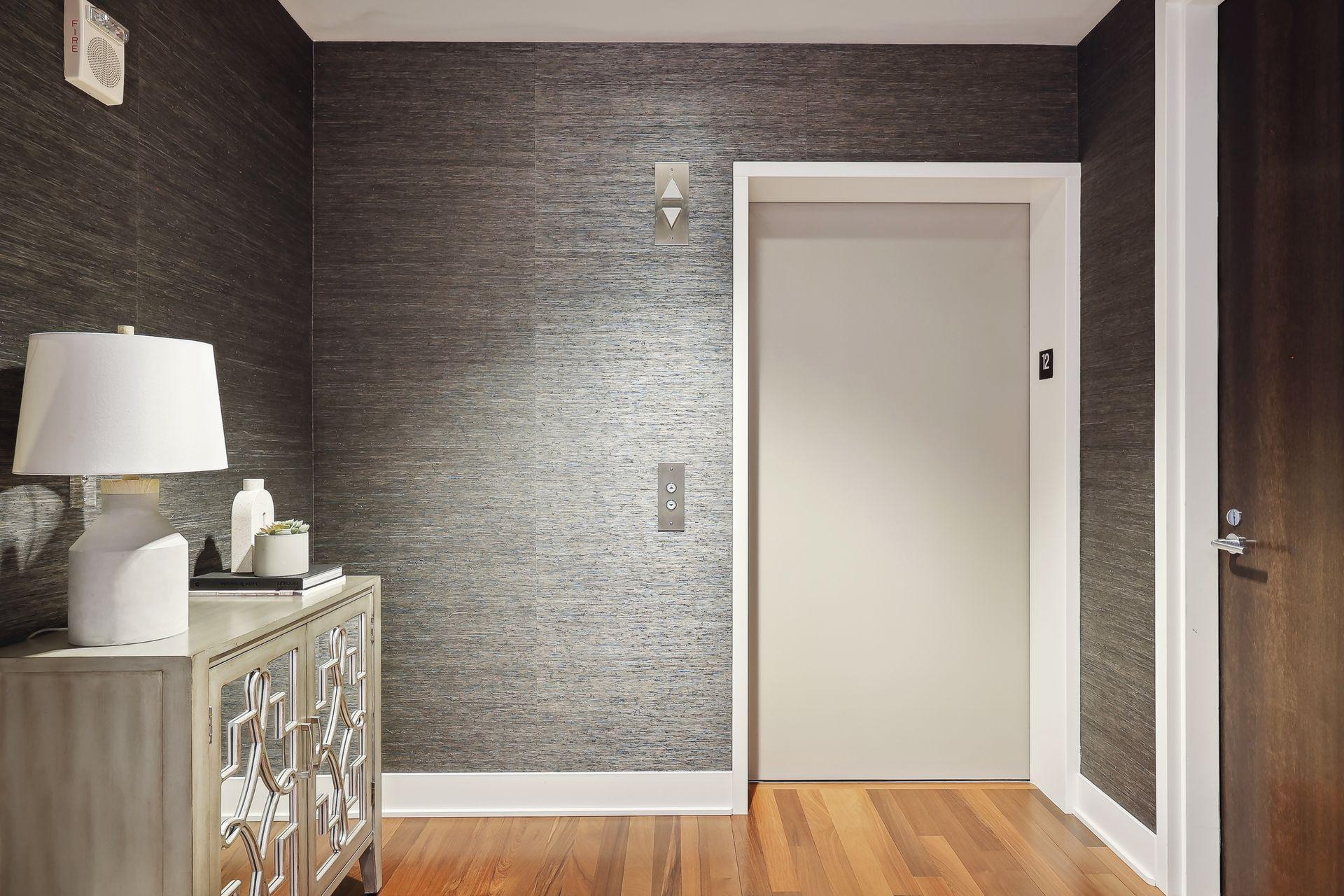 The luxury of having a private elevator! Step from your penthouse elevator into the ample foyer with guest closet, the walls are covered with washable grasscloth.