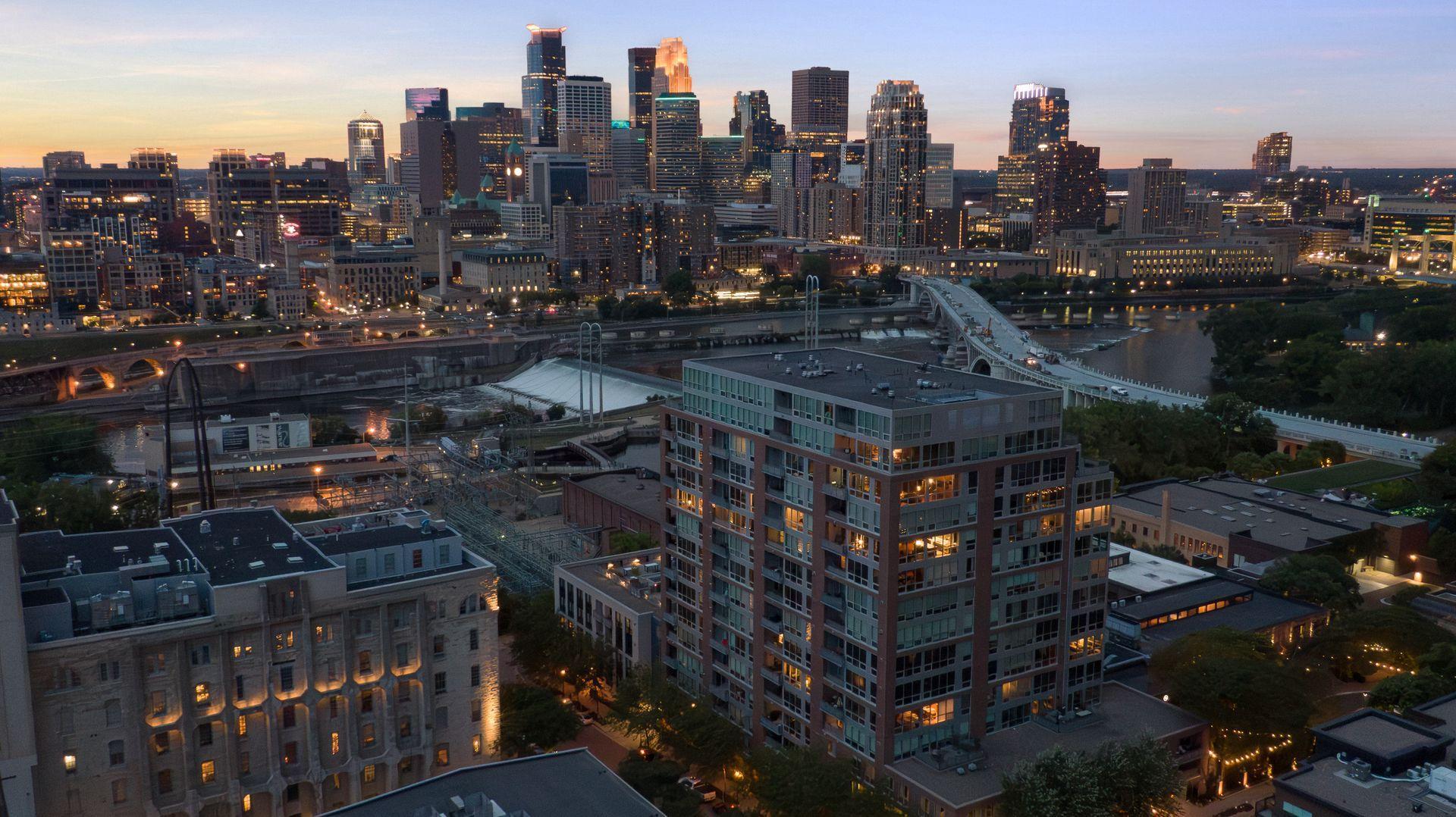 Phoenix on the River dominates the foreground with St Anthony Falls, the lock and dam and Minneapolis skyline as a backdrop.