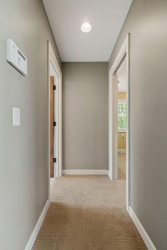 Hallway to walk-in closet and primary bath