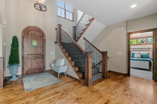 Open staircase features alder railings w/ iron accents