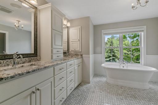 Enameled vanity cabinet w/ granite countertops and dual undermount sinks with additional linen and medicine cabinets that offer added storage