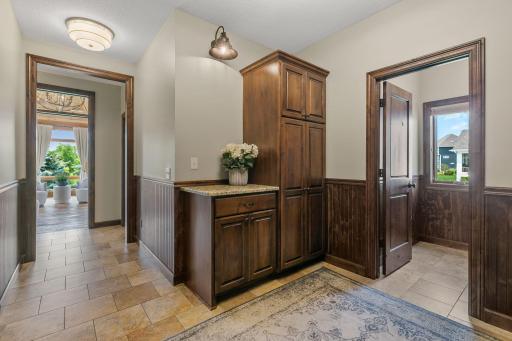 Alder drop station cabinet w/ granite top and travertine tile flooring