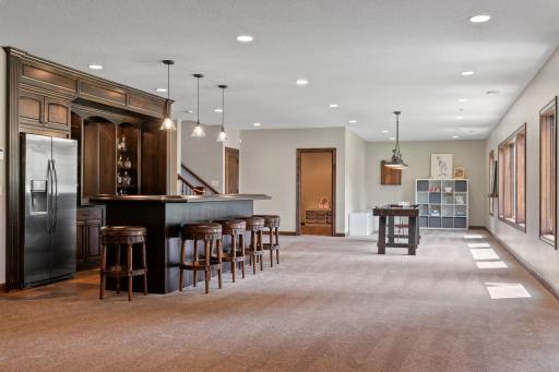 Roll-out storage w/ full sized refrigerator, microwave and large center island w/ raised countertops