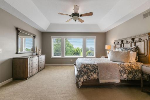 Large windows offer treetop views of the property