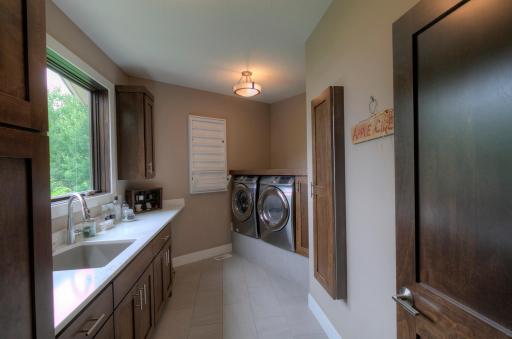 Stainless washer and dryer on a pedestal for easy use.