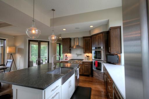 The island has a granite countertop and is the perfect workspace. Other counters and backsplash are Vicostone Statuario.