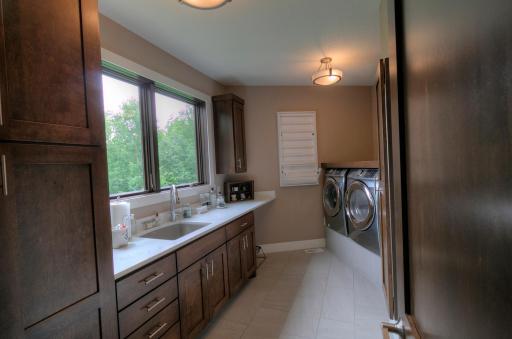 Laundry room - main floor. Hard surface counters-birch cabinets.