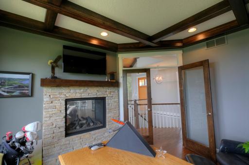 Two-sided gas fireplace can be seen from the study and the living room.