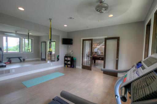 Lower-level exercise room with cork flooring and in-floor hear.