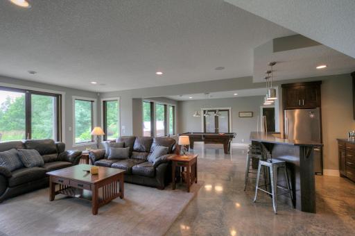Family room in the lower-level has a stained concrete floor with in-floor heat.