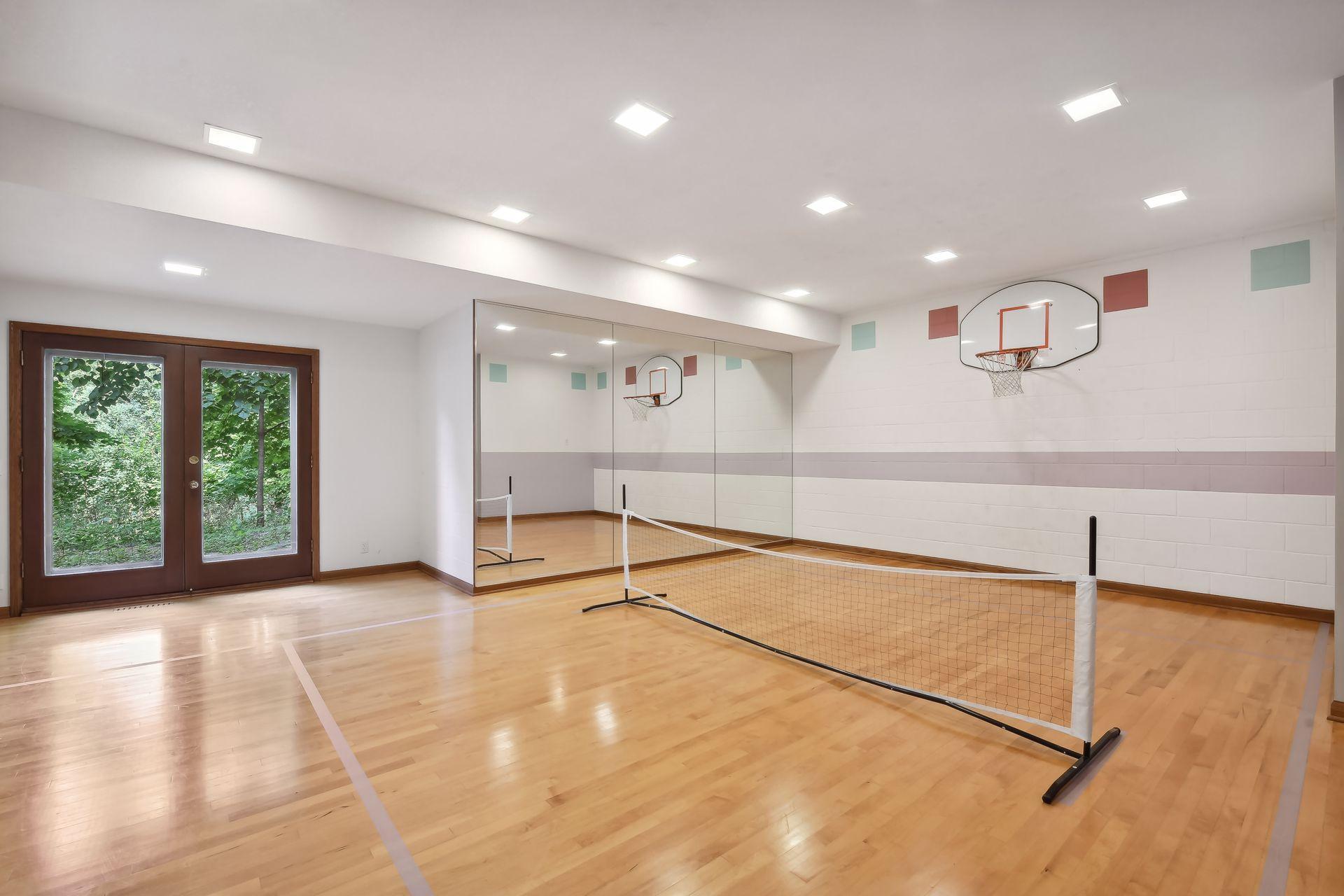 Lower level sport court with walk out to backyard.