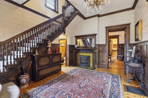 Photo for 495 Summit Avenue, Saint Paul, MN 55102 - Listing #6400517 The grand staircase guides you to the second floor, featuring a large fireplace, adorned with beautifully crafted tiles and carved wood