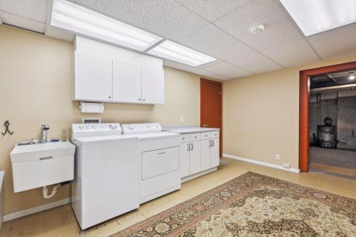 Photo for 495 Summit Avenue, Saint Paul, MN 55102 - Listing #6400517 Venturing to the lower level, A well-equipped laundry room with ample storage keeps everything organized