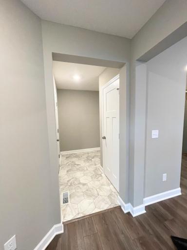 This hallway leads to the mudroom with garage access and main floor powder room. Photos are of the actual, available home.