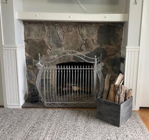 Vintage stone real fireplace in bedroom. Being used but current codes says need metal liner