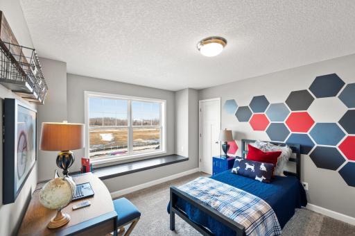 One of three generously sized secondary bedrooms with a spacious closet! Photo of identical Lewis floorplan. Actual home finishes may vary.