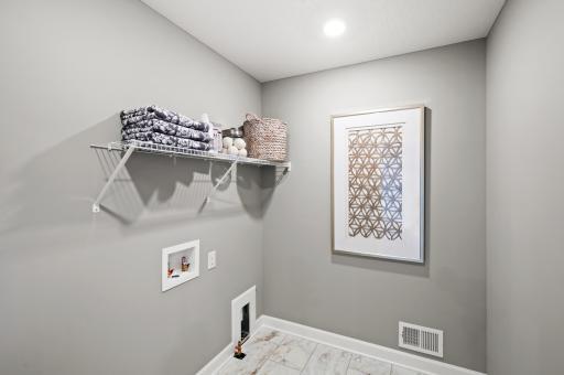One of life's simple pleasures. Conveniently located on the second level, this plan features upper-level laundry just steps from each of the four upper level bedrooms. Photo of identical Lewis floorplan. Actual home finishes may vary.