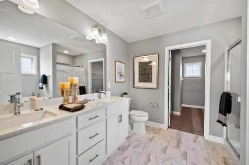 An extension of the owner's suite, this private and spacious bath contains a double-vanity, and separate shower and tub. Photo of identical Lewis floorplan. Actual home finishes may vary.
