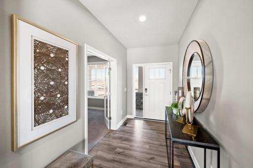 Stunning front entry with easy flex room access for a perfect office, or overflow living space. Photo of identical Lewis floorplan. Actual home finishes may vary.