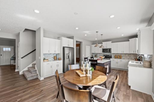 The main level living area is enhanced by the modern 9’ high knockdown ceilings and the open concept floorplan that flows from room to room. Photo of identical Lewis floorplan. Actual home finishes may vary.