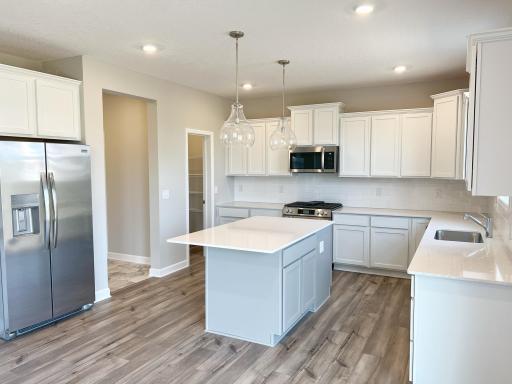 Staggered height kitchen cabinets and natural stone countertops now installed.