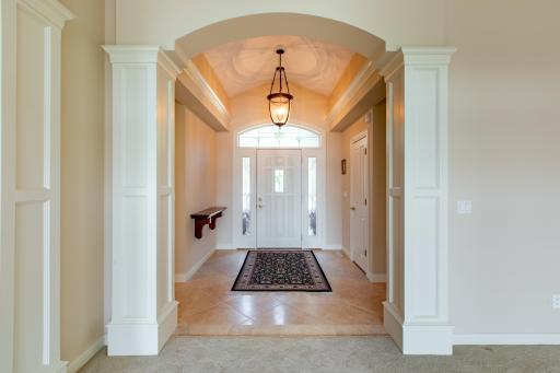 Stunning entrance with vaulted ceiling and crown molding