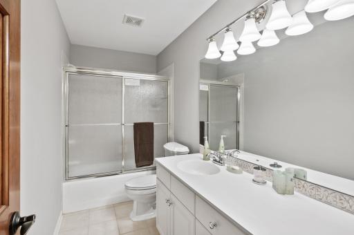 upper level bath shared by two bedrooms with ample storage.