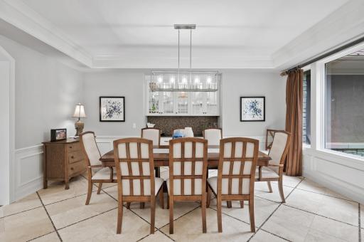 Your formal dining room is complete with lots of natural light and a serving bar and beautiful upper cabinets.