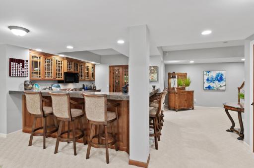 The full kitchen/bar includes a custom wine cellar.
