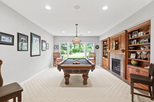 This billiards room is a wonderful place to spend time with family and friends by the two sides fireplace and cherry built-ins.