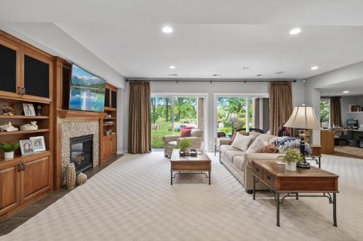 Your lower-level living room also has lots of natural light, gas fireplace, and beautiful cherry cabinetry. Yet another place that makes you feel cozy and welcome.