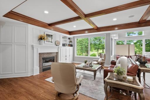 Your main level family room features a fireplace, cherry accents, and panoramic views of the 11th green.