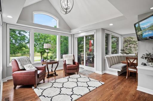 The sunroom leads to a maintenance free deck overlooking the backyard and outdoor waterfall.