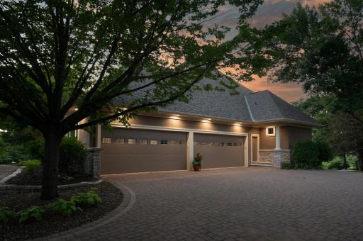 This amazing paver driveway and LED lighting welcome you back to your oversized 4 stall garage.