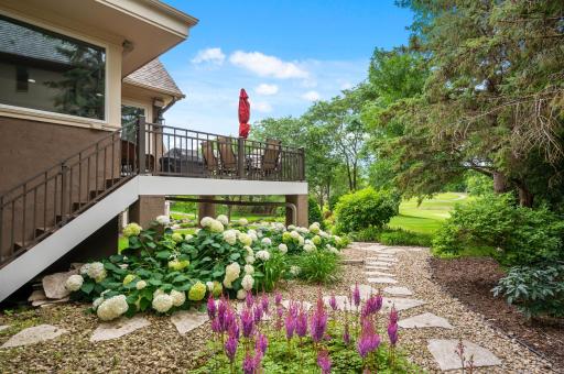 Walking down the stone path from the garage, you are welcomed to your backyard oasis.