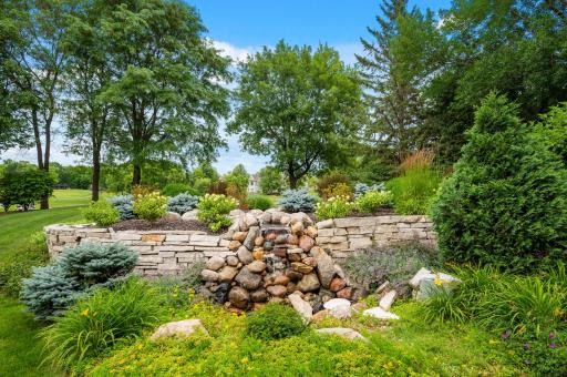 The backyard waterfall offers peaceful surroundings for your large patio.