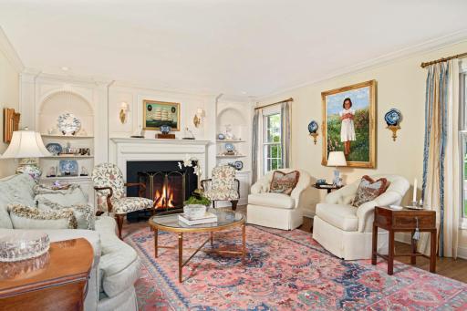 Formal Living room with a custom built fireplace mantel with reversed shell built-ins