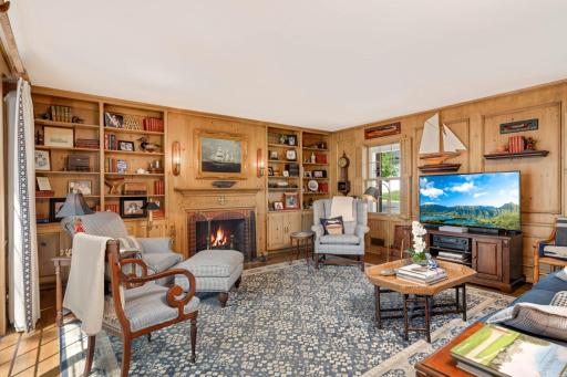 A woodburning fireplace flanked by bookcases