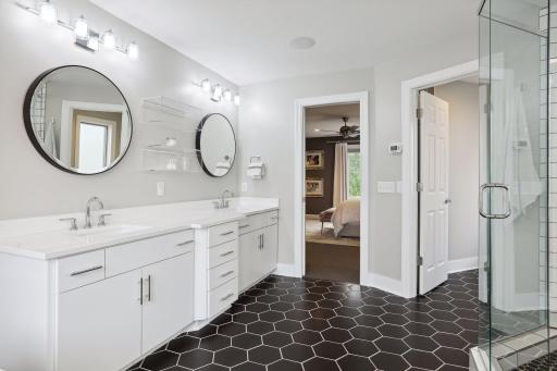 Primary bathroom with dual vanity, soaking tub, and walk-in shower