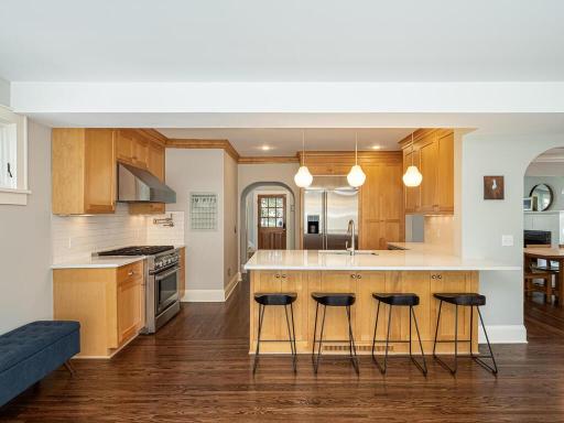 Kitchen with breakfast bar eat-in opens to spacious family room.