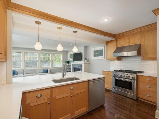 Family room with new gas fireplace, walls of windows and views of the fully fenced backyard.
