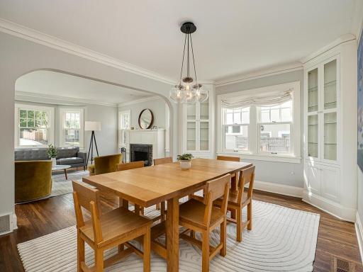 Dining room with modern lighting and custom cabinets.