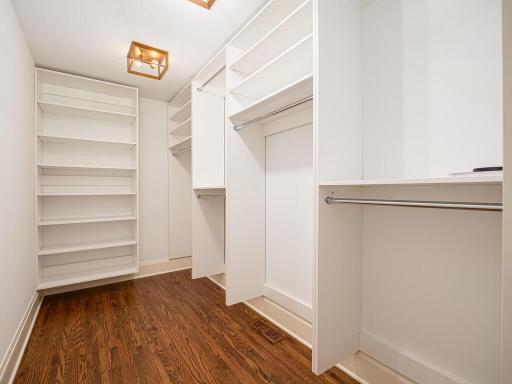 Primary bedroom walk-in closet and built-in organizers.