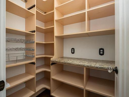 Walk-in pantry with outlets for a coffee bar and appliances.