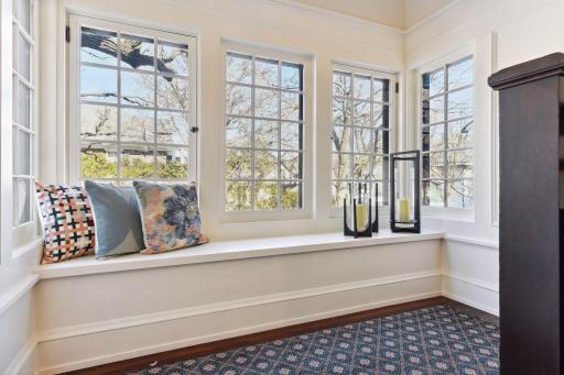 Sunny bay window seat at the landing leading to the second floor.